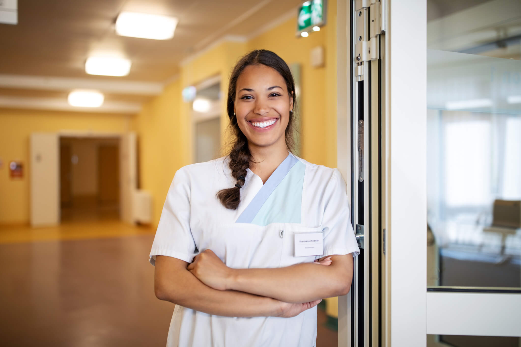 Female nurse standing at doorway