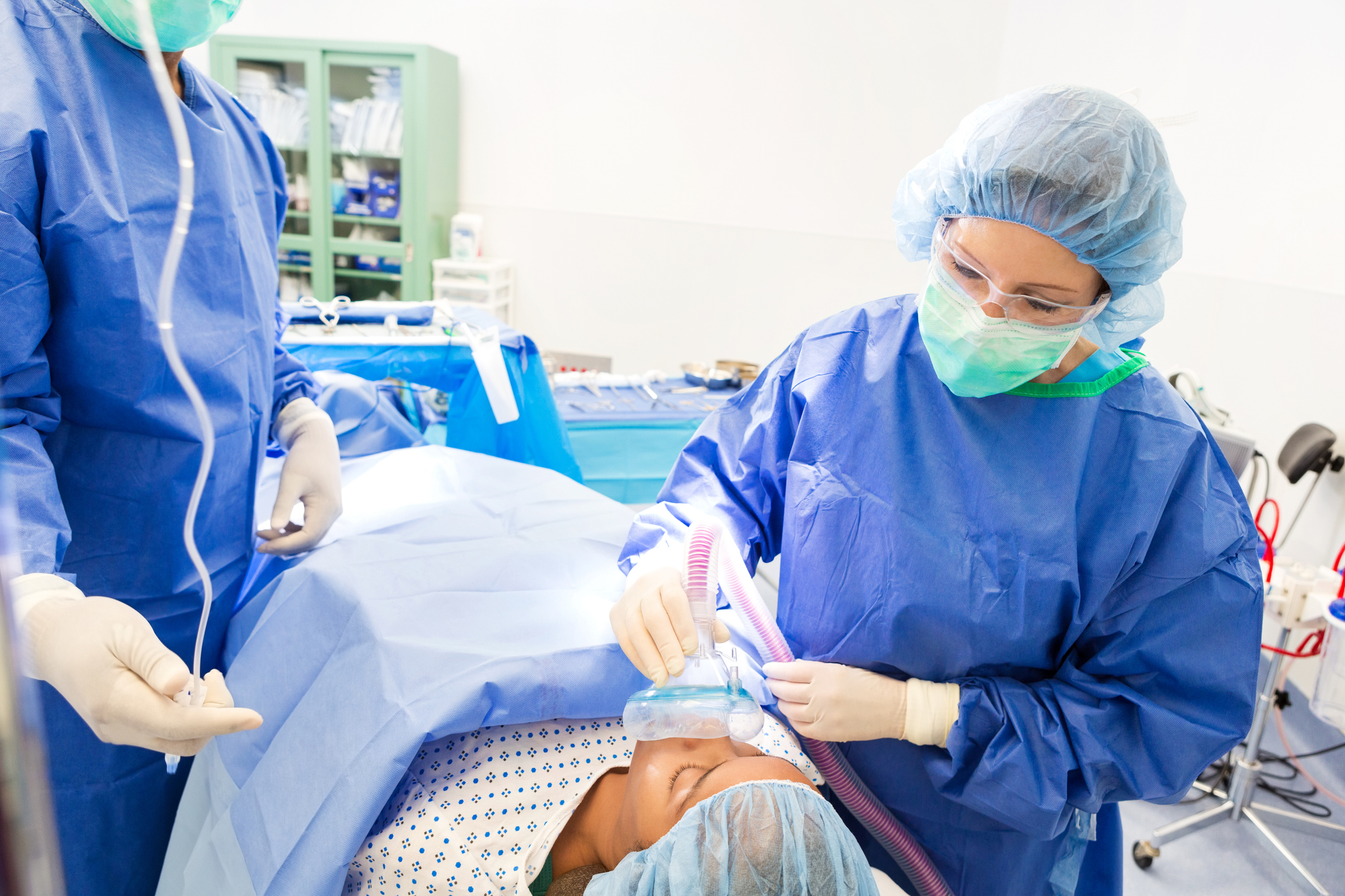 Medical professional sedating a patient before surgery