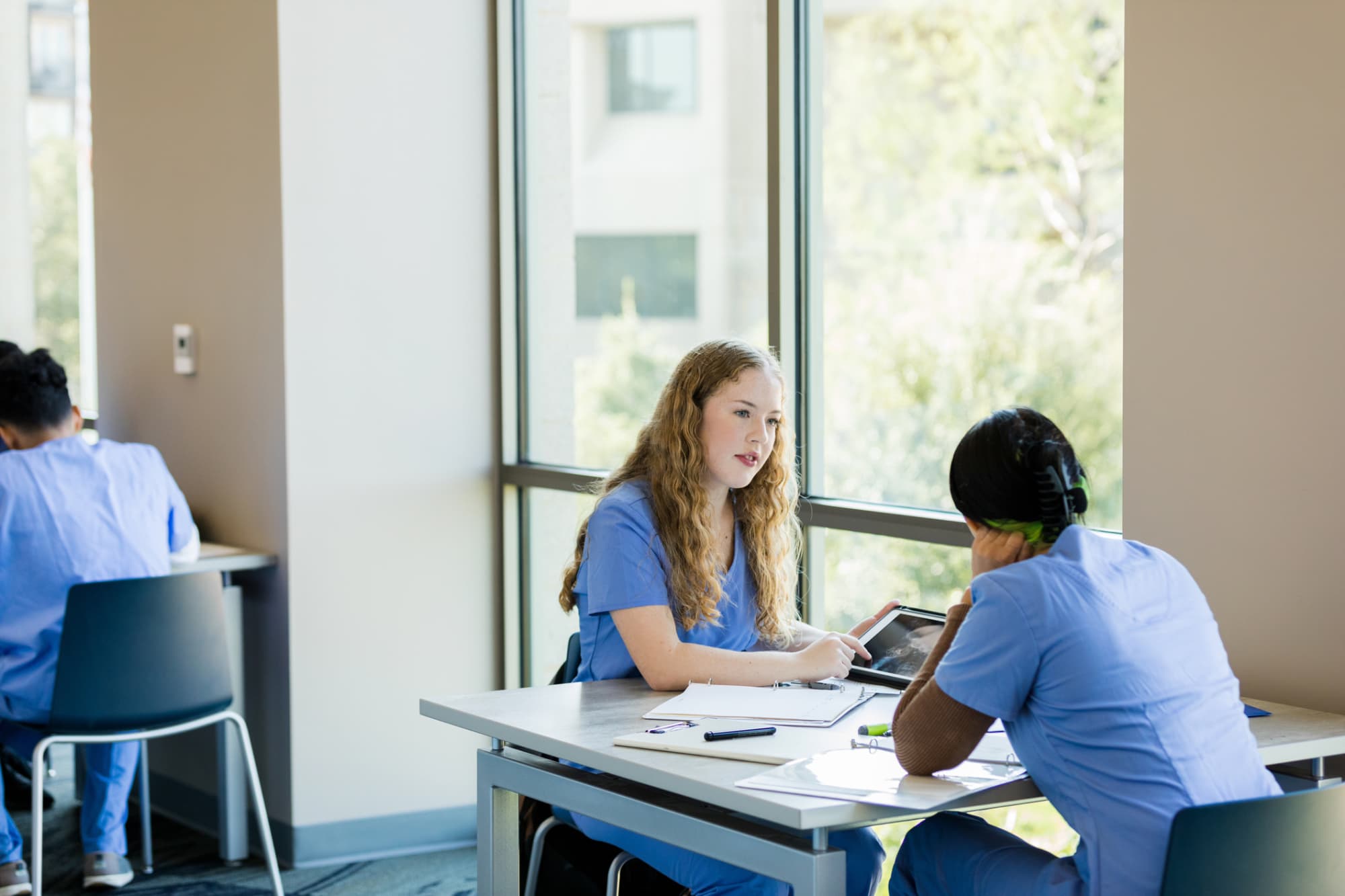 Nursing students studying together at a table