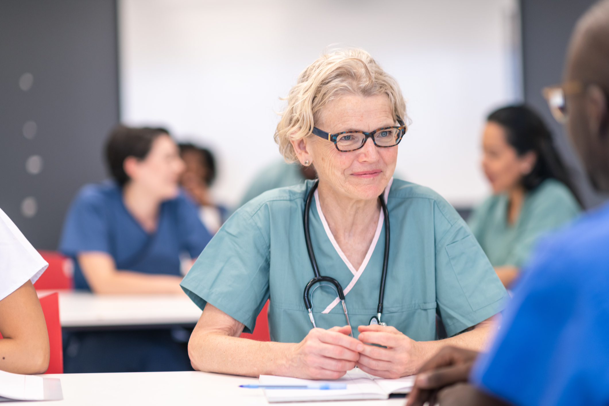 Older adult nurse learning in a classroom setting