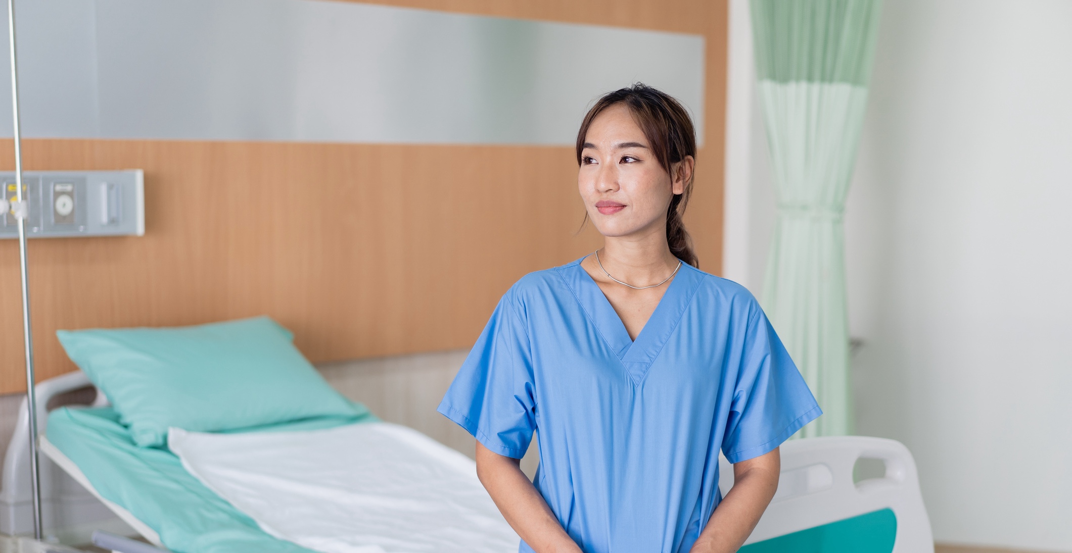 Nurse standing in empty hospital room